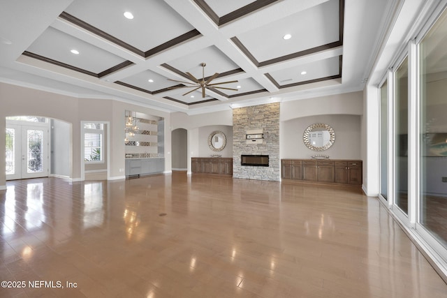452 Deer Valley Dr, Ponte Vedra, FL 32081 - unfurnished living room with arched walkways, ceiling fan, coffered ceiling, a fireplace, and beam ceiling