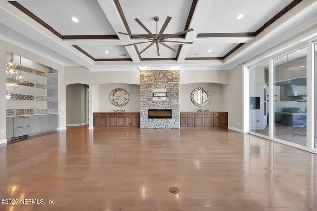 452 Deer Valley Dr, Ponte Vedra, FL 32081 - unfurnished living room with a fireplace, coffered ceiling, arched walkways, beam ceiling, and crown molding
