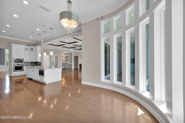 452 Deer Valley Dr, Ponte Vedra, FL 32081 - kitchen featuring crown molding, open floor plan, light wood-style flooring, recessed lighting, and white cabinetry