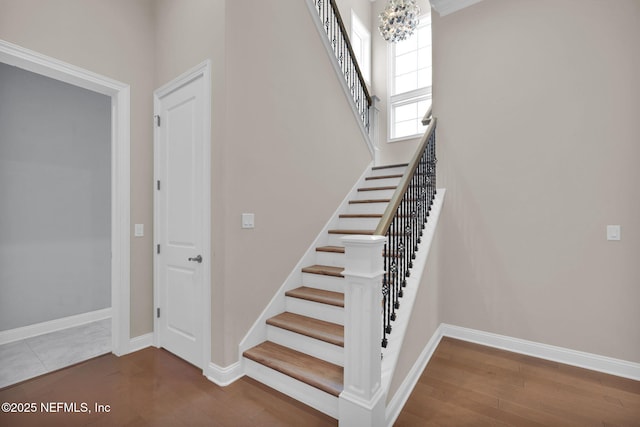 452 Deer Valley Dr, Ponte Vedra, FL 32081 - stairway with a chandelier, wood finished floors, and a high ceiling