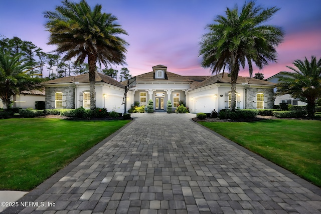 452 Deer Valley Dr, Ponte Vedra, FL 32081 - view of front of home with french doors, a garage, stucco siding, decorative driveway, and a yard