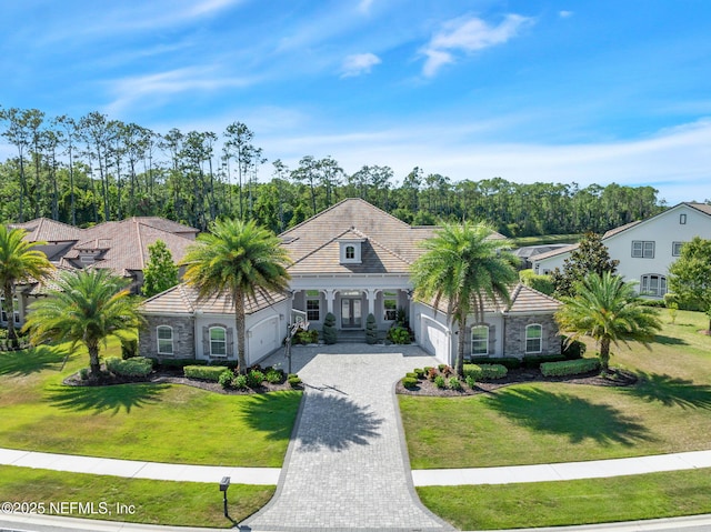 452 Deer Valley Dr, Ponte Vedra, FL 32081 - view of front facade with a garage, decorative driveway, a front lawn, and stone siding