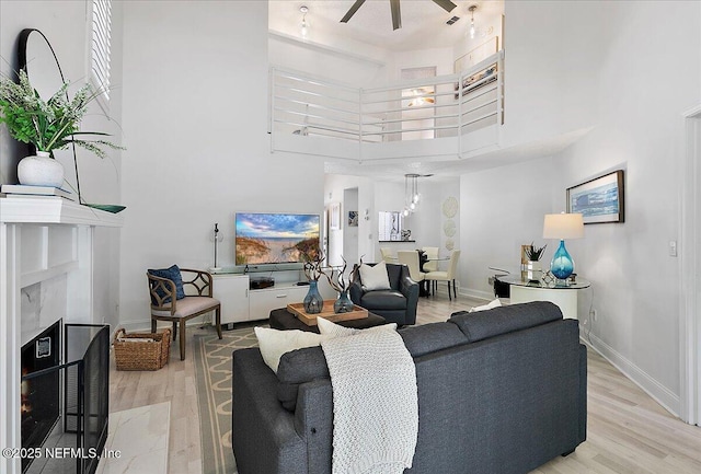 35 Turtleback Trl, Ponte Vedra Beach, FL 32082 - living room featuring a towering ceiling, ceiling fan, light wood-style floors, and a premium fireplace