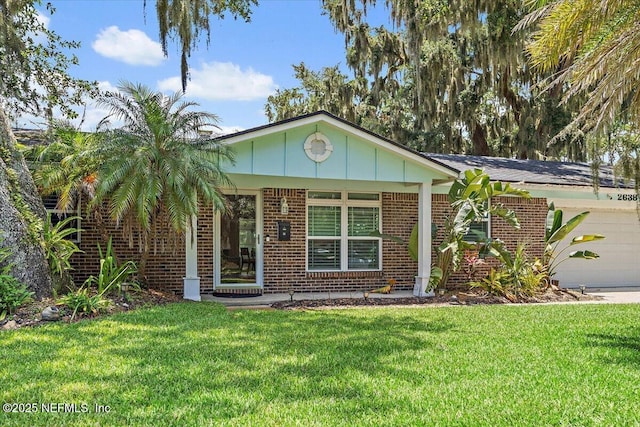2638 W End St, Jacksonville, FL 32233 - ranch-style home with brick siding, a front yard, and a garage