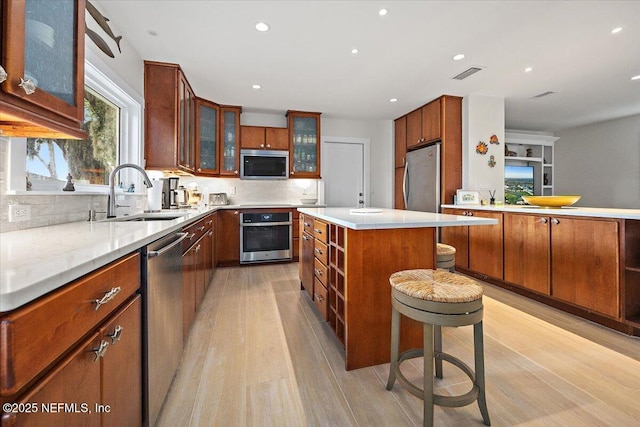 2638 W End St, Jacksonville, FL 32233 - kitchen featuring appliances with stainless steel finishes, light wood-style floors, backsplash, recessed lighting, and light countertops