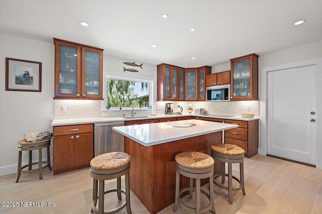 2638 W End St, Jacksonville, FL 32233 - kitchen with stainless steel appliances, decorative backsplash, light countertops, a breakfast bar, and recessed lighting