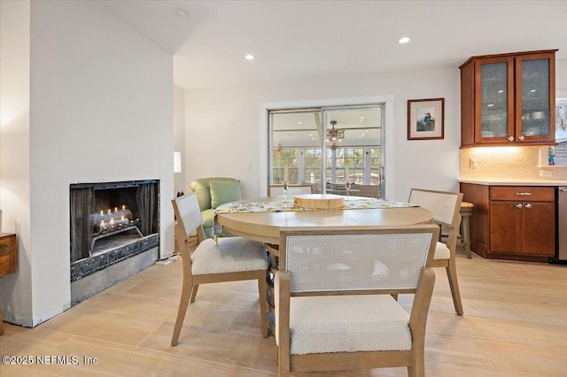 2638 W End St, Jacksonville, FL 32233 - dining room with a warm lit fireplace, recessed lighting, and light wood-style floors