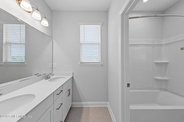 117 Redbud Ln, Yulee, FL 32097 - bathroom with double vanity, washtub / shower combination, plenty of natural light, and tile patterned floors