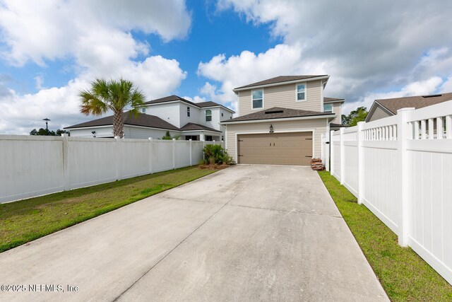 117 Redbud Ln, Yulee, FL 32097 - view of front facade with an attached garage, driveway, and a shingled roof