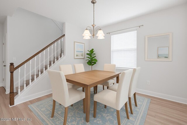 117 Redbud Ln, Yulee, FL 32097 - dining room featuring stairway, light wood-type flooring, and a chandelier
