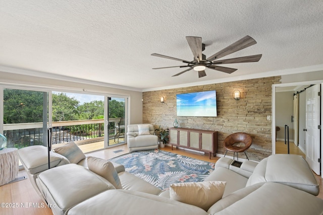 136 Sherwood Ave, Saint Augustine, FL 32084 - living room with light wood finished floors, crown molding, a textured ceiling, and ceiling fan