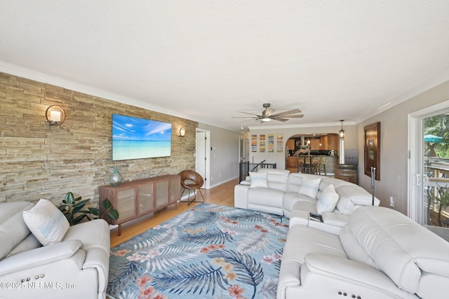 136 Sherwood Ave, Saint Augustine, FL 32084 - living room with wood finished floors, ornamental molding, a ceiling fan, arched walkways, and an accent wall