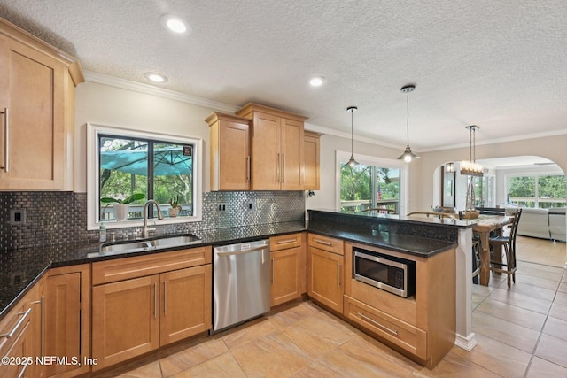 136 Sherwood Ave, Saint Augustine, FL 32084 - kitchen with appliances with stainless steel finishes, arched walkways, a peninsula, ornamental molding, and tasteful backsplash