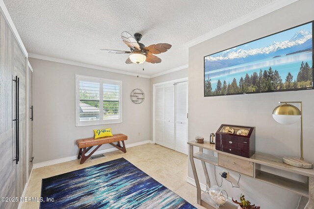 136 Sherwood Ave, Saint Augustine, FL 32084 - foyer featuring a ceiling fan, ornamental molding, light tile patterned floors, and a textured ceiling