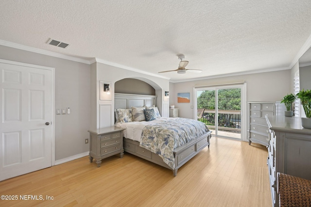 136 Sherwood Ave, Saint Augustine, FL 32084 - bedroom featuring access to outside, light wood-style floors, a textured ceiling, crown molding, and arched walkways