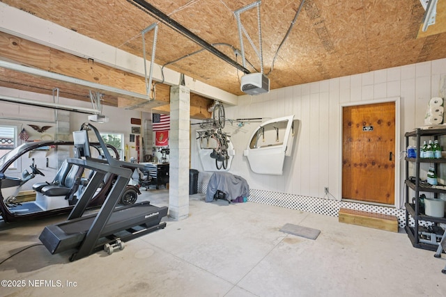 136 Sherwood Ave, Saint Augustine, FL 32084 - exercise area featuring a garage and wood walls