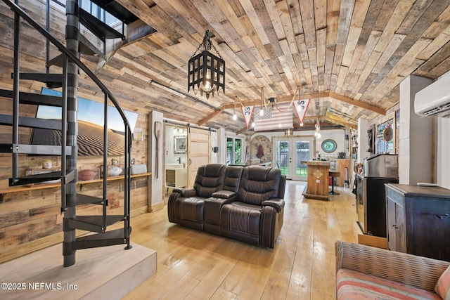 136 Sherwood Ave, Saint Augustine, FL 32084 - living area featuring lofted ceiling, light wood finished floors, a wall unit AC, wooden ceiling, and stairway