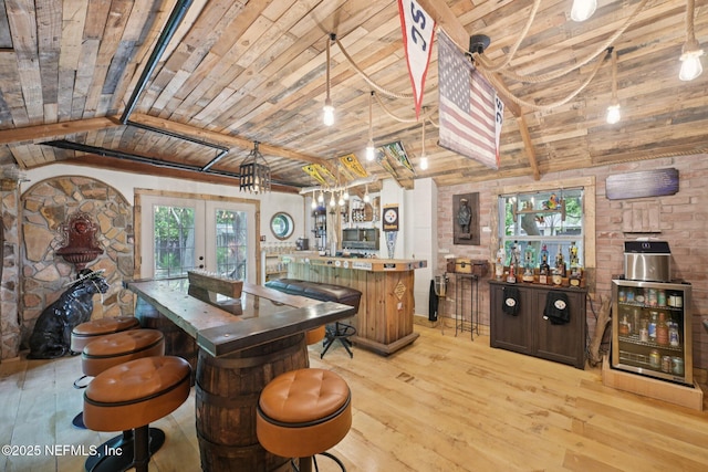 136 Sherwood Ave, Saint Augustine, FL 32084 - indoor bar with wood ceiling, light wood-style floors, french doors, and stainless steel microwave