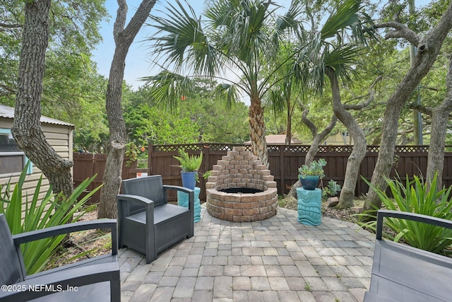136 Sherwood Ave, Saint Augustine, FL 32084 - fenced backyard with a patio area and an outdoor fire pit