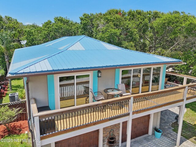 136 Sherwood Ave, Saint Augustine, FL 32084 - back of house with a metal roof, a garage, a deck, and stucco siding