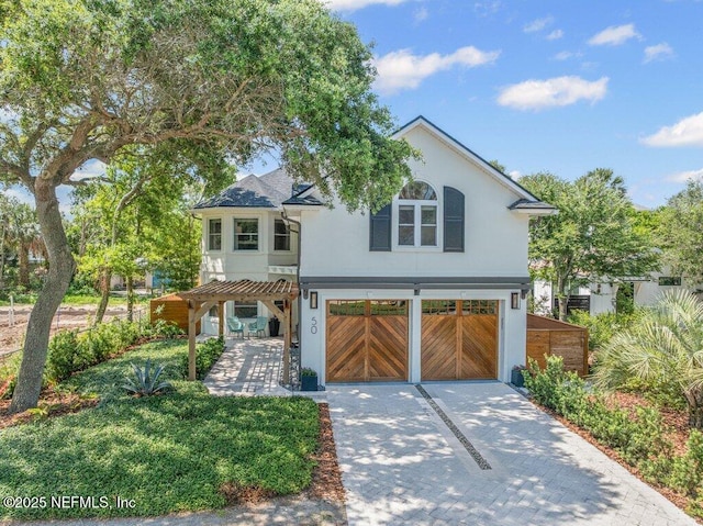 50 17th St, Atlantic Beach, FL 32233 - view of front of house featuring driveway, a garage, and stucco siding