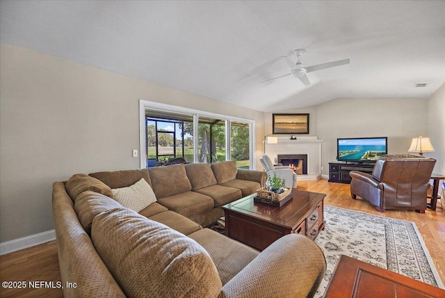 105 Lucina Ln, Ponte Vedra Beach, FL 32082 - living area with lofted ceiling, light wood finished floors, a ceiling fan, and a warm lit fireplace