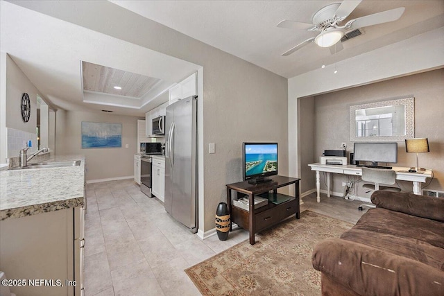 105 Lucina Ln, Ponte Vedra Beach, FL 32082 - living room with a desk, ceiling fan, a raised ceiling, and light tile patterned floors