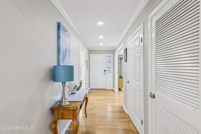 12137 Dividing Oaks Trl E, Jacksonville, FL 32223 - hall featuring ornamental molding, light wood-style floors, recessed lighting, and a textured ceiling