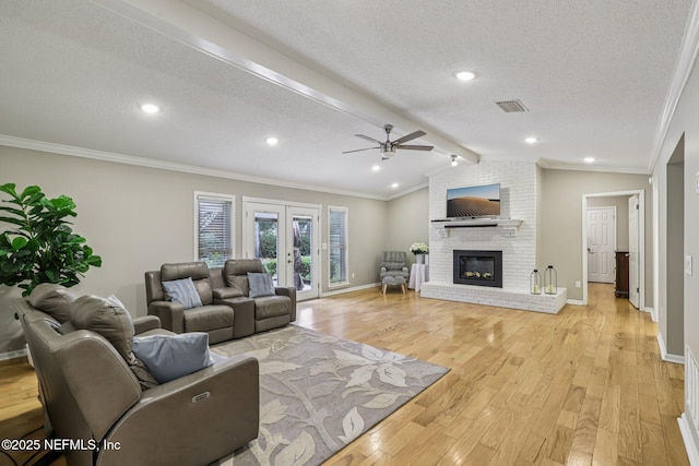 12137 Dividing Oaks Trl E, Jacksonville, FL 32223 - living area featuring ceiling fan, light wood-type flooring, ornamental molding, a textured ceiling, and a fireplace