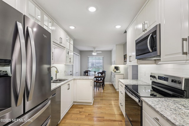 12137 Dividing Oaks Trl E, Jacksonville, FL 32223 - kitchen featuring stainless steel appliances, light wood finished floors, a ceiling fan, recessed lighting, and white cabinets