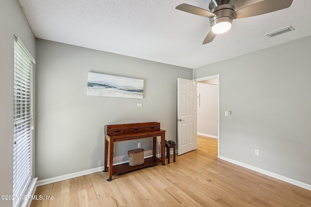 12137 Dividing Oaks Trl E, Jacksonville, FL 32223 - bedroom with light wood-style floors, a textured ceiling, and ceiling fan