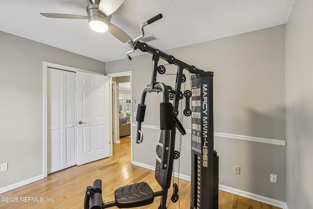 12137 Dividing Oaks Trl E, Jacksonville, FL 32223 - exercise area featuring a ceiling fan, wood finished floors, and a textured ceiling
