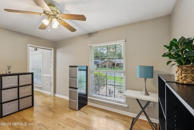 12137 Dividing Oaks Trl E, Jacksonville, FL 32223 - office area with light wood finished floors, a ceiling fan, and a textured ceiling