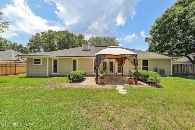 12137 Dividing Oaks Trl E, Jacksonville, FL 32223 - back of property with a gazebo, a patio, a chimney, and roof with shingles