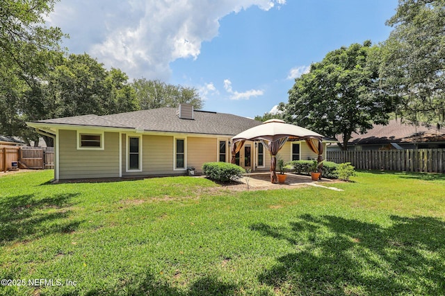 12137 Dividing Oaks Trl E, Jacksonville, FL 32223 - back of property featuring a gazebo, a fenced backyard, a patio, a chimney, and roof with shingles