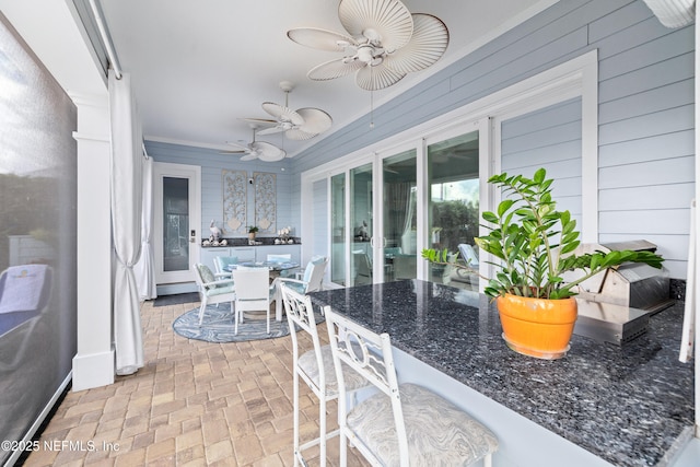 651 Rum Runner Way, Saint Johns, FL 32259 - kitchen featuring brick patterned flooring, a ceiling fan, dark stone countertops, and wooden walls