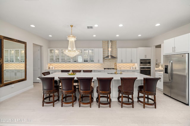 651 Rum Runner Way, Saint Johns, FL 32259 - kitchen with stainless steel appliances, wall chimney range hood, light countertops, decorative backsplash, and recessed lighting
