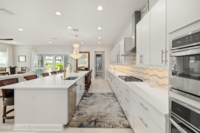 651 Rum Runner Way, Saint Johns, FL 32259 - kitchen featuring stainless steel appliances, recessed lighting, healthy amount of natural light, wall chimney range hood, and light countertops