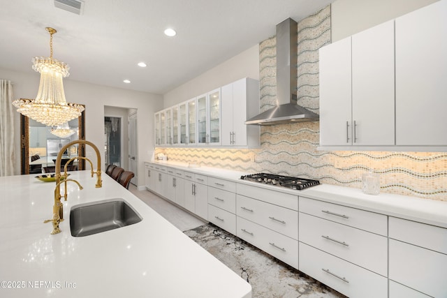 651 Rum Runner Way, Saint Johns, FL 32259 - kitchen featuring wall chimney range hood, stainless steel gas stovetop, a chandelier, recessed lighting, and light countertops