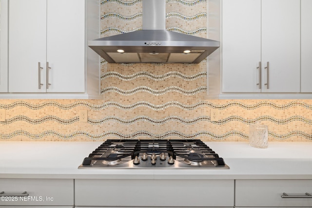 651 Rum Runner Way, Saint Johns, FL 32259 - kitchen view of under cabinet range hood, stainless steel gas stovetop, light countertops, decorative backsplash, and white cabinetry