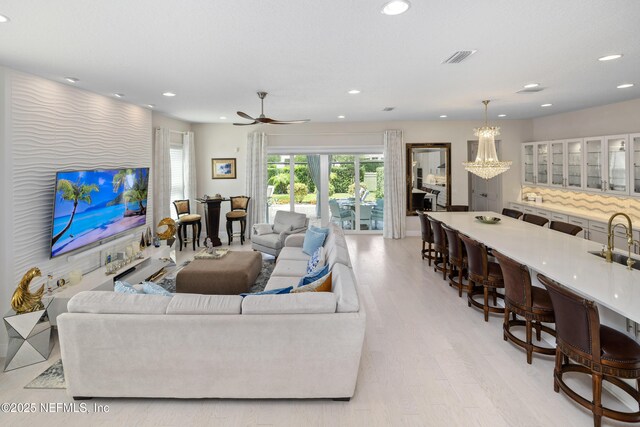 651 Rum Runner Way, Saint Johns, FL 32259 - living room featuring light wood-type flooring, recessed lighting, a ceiling fan, and a chandelier