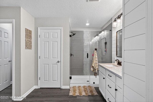 665 Flach Dr, Saint Johns, FL 32259 - bathroom featuring vanity, a shower stall, wood finished floors, a textured ceiling, and recessed lighting