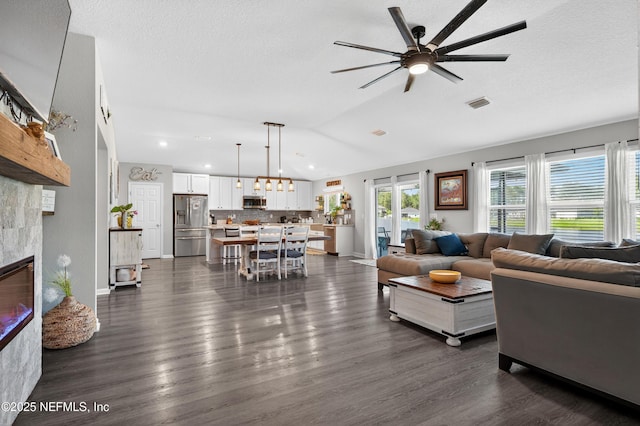 665 Flach Dr, Saint Johns, FL 32259 - living area featuring vaulted ceiling, ceiling fan, a tile fireplace, dark wood-type flooring, and recessed lighting
