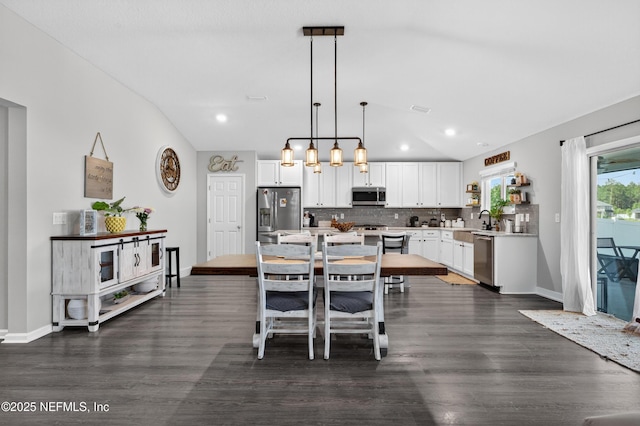 665 Flach Dr, Saint Johns, FL 32259 - dining area with lofted ceiling, dark wood-type flooring, and recessed lighting