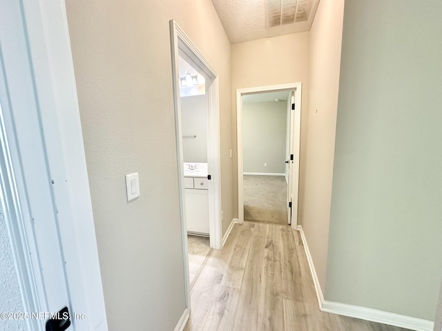 356 Bermudez Way, Saint Augustine, FL 32095 - corridor with light wood-type flooring and a textured ceiling