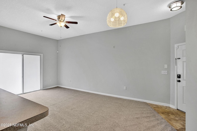 7920 Merrill Rd Unit 403, Jacksonville, FL 32277 - unfurnished living room featuring a ceiling fan, carpet floors, and a textured ceiling