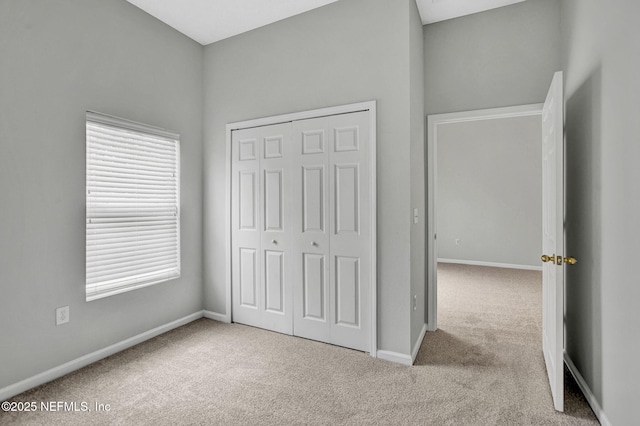 7920 Merrill Rd Unit 403, Jacksonville, FL 32277 - unfurnished bedroom with carpet, a closet, and multiple windows