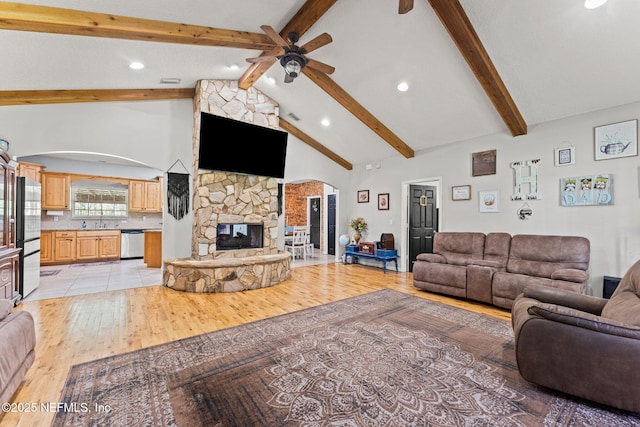 34100 Old Baldwin Rd, Callahan, FL 32011 - living area featuring arched walkways, ceiling fan, a stone fireplace, light wood-style floors, and recessed lighting