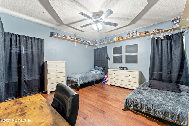 34100 Old Baldwin Rd, Callahan, FL 32011 - bedroom featuring a textured ceiling, wood finished floors, and ceiling fan