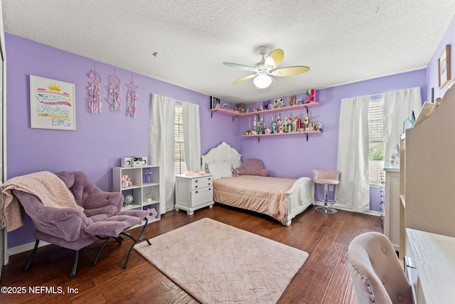 34100 Old Baldwin Rd, Callahan, FL 32011 - bedroom featuring multiple windows, dark wood-style floors, ceiling fan, and a textured ceiling